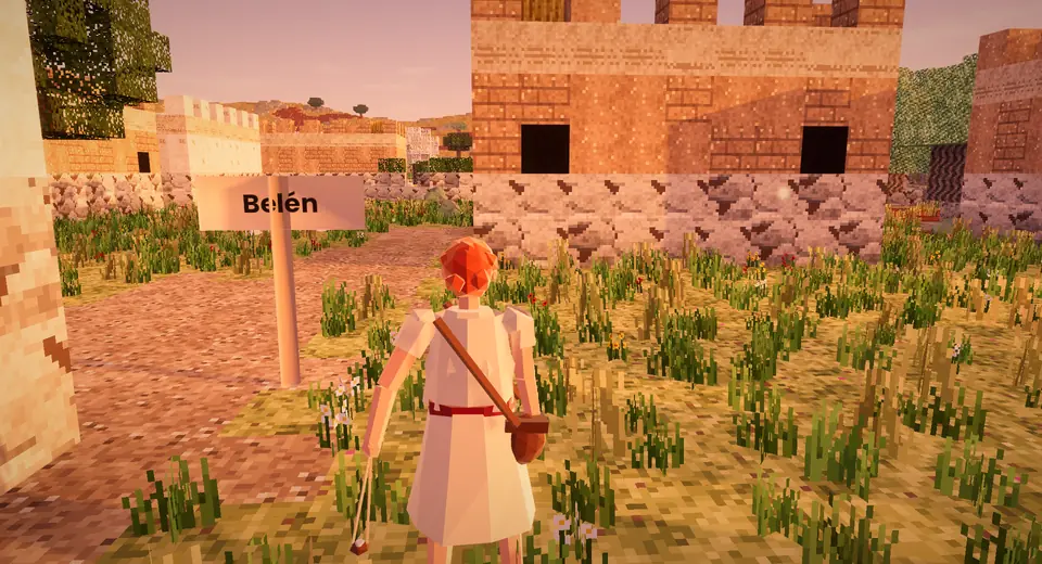 Belén a la hora dorada en el mundo abierto del juego, con casas de bloques y pasto.